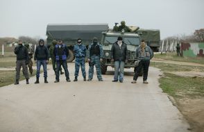 People with guns and hidden faces