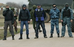 People with guns and hidden faces