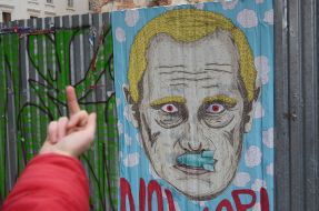"A pillar of shame", hung on all sides by images of Putin