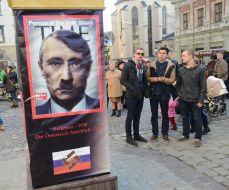 "A pillar of shame", hung on all sides by images of Putin