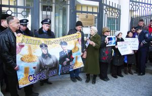 Activists hold placards