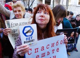 Activists hold placards