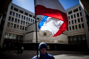 A man holding a flag of ARC
