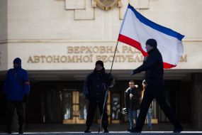 A man holding a flag of ARC