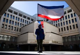 A man holding a flag of ARC