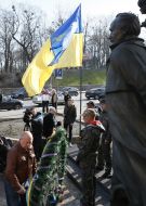 Laying flowers at the monument to Chornovol
