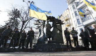 Laying flowers at the monument to Chornovol