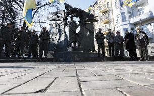 Laying flowers at the monument to Chornovol