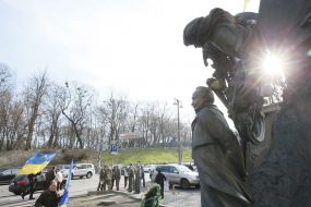 Laying flowers at the monument to Chornovol