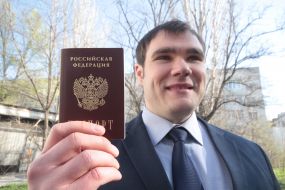 Young man holding a Russian passport