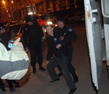 Police officers put in a paddy wagon party clashes