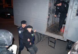 Police officers put in a paddy wagon party clashes