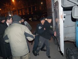 Police officers put in a paddy wagon party clashes