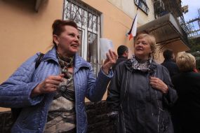 A woman holds a Russian passport