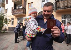 A man holds a Russian passport