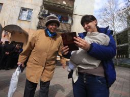 A woman holds a Russian passport