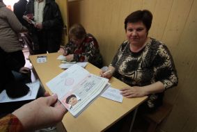 A woman holds a Russian passport