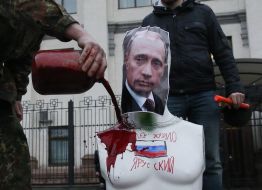 Activist pours blood mannequin with Putin's portrait