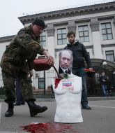 Activist pours blood mannequin with Putin's portrait