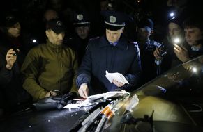 Militioner inspects auto of Oleg Tsarev