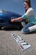 Girl changes the Ukrainian automobile license plate on the license plate of the RF