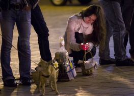 A girl  kindles a candle