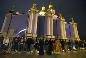 A priest sanctifies easter baskets
