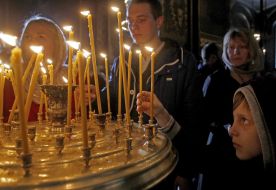Boy lighting a candle
