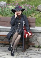 A woman speaks on a mobile telephone