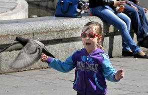 Girl runs a pigeon