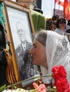 A woman kisses the portrait of the marshal Zhukov
