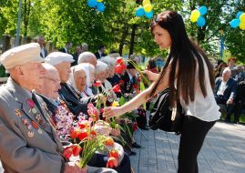 A girl gives flowers to the veterans
