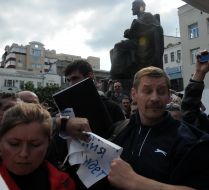 A man holds a placard