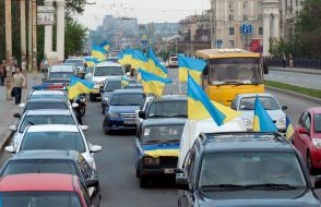 participants  of parade Ukrainian flags