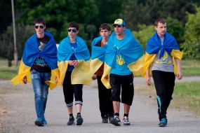 participants  of parade Ukrainian flags