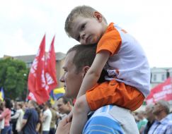 A man holding a boy on his shoulders