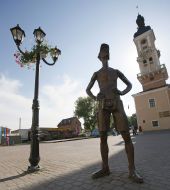 Monument to tourist on the background of the town hall