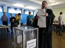 Priest near the ballot box