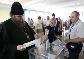 Priest near the ballot box