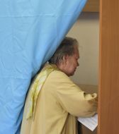 A woman calls at a polling-booth
