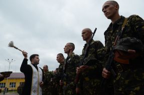 The priest blesses the soldiers