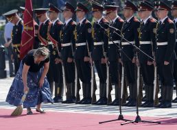 Woman sweeping the red carpet