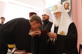Patriarch Filaret presenting diplomas to students, theologians