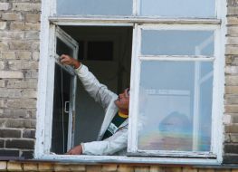 Man makes measurements of glass