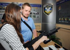 Visitors inspect weapons