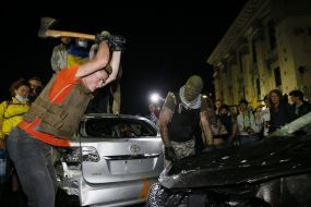 Protesters smash car