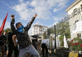 Protesters throw stones at the Russian Embassy