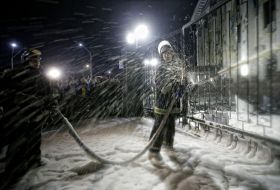 Firefighter pours foam territory near the Russian Embassy