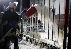 Firefighter pours foam territory near the Russian Embassy