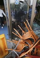 Chairs near the broken glass door of the hotel